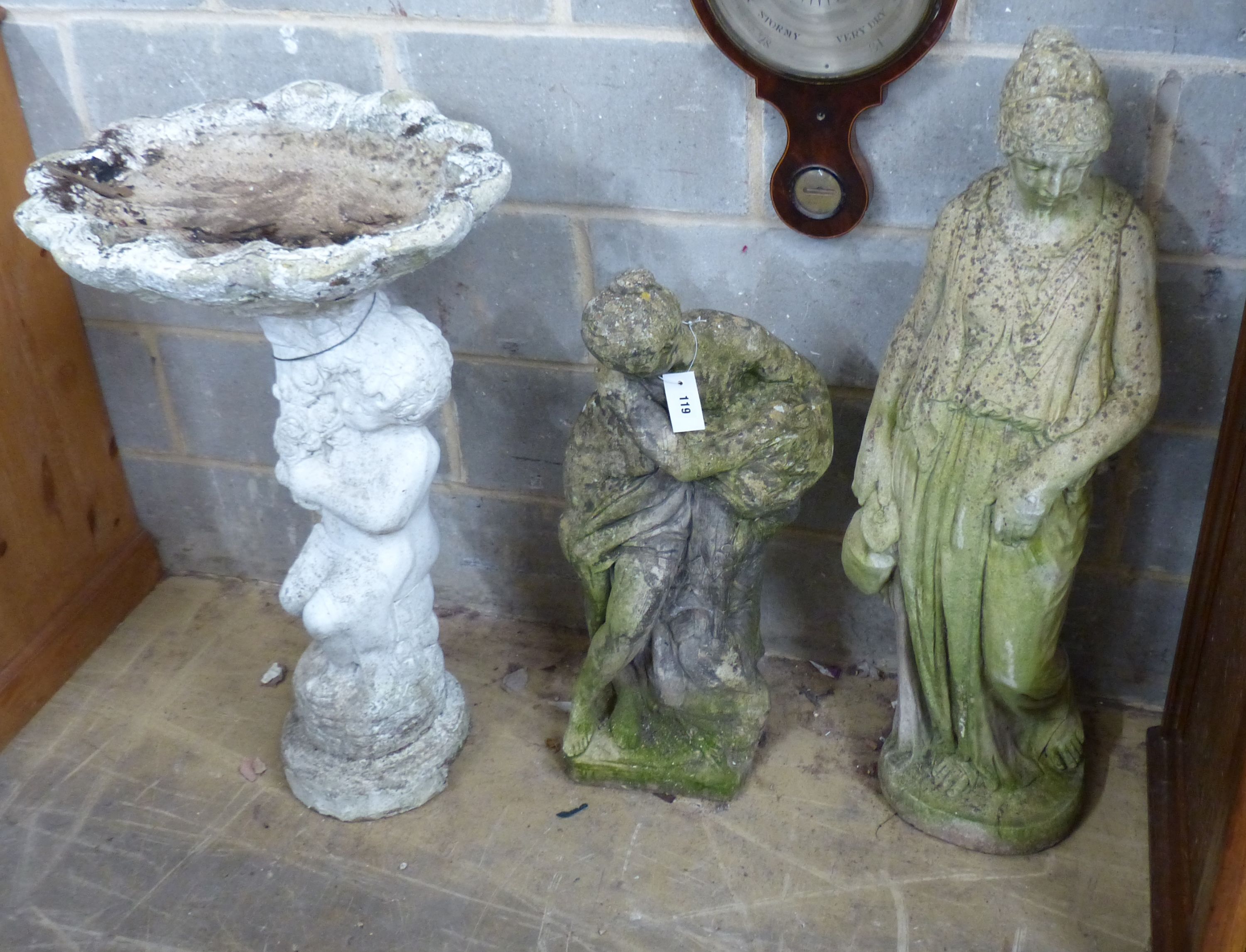 Two reconstituted stone garden statues and a bird bath, largest height 99cm